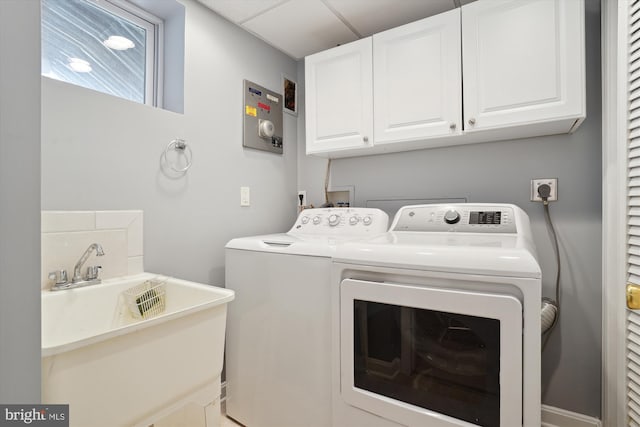 laundry area with cabinets, sink, and independent washer and dryer