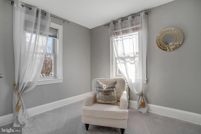 living area with plenty of natural light and carpet floors