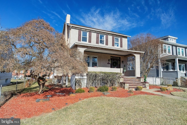 view of property featuring a porch and a front yard