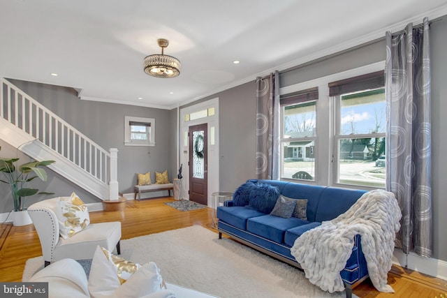 living room with wood-type flooring and ornamental molding