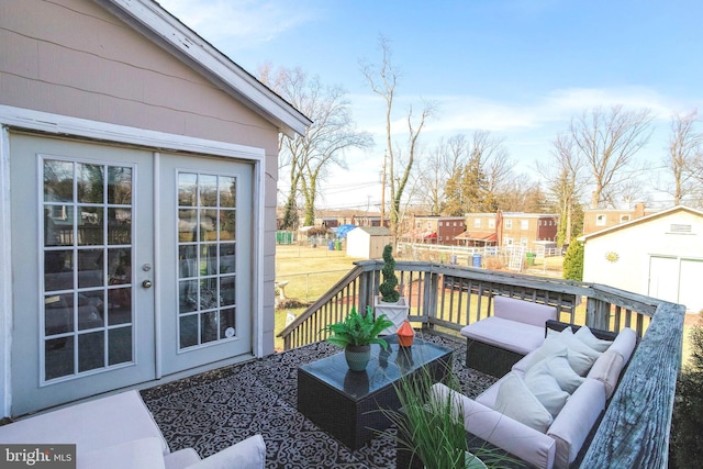 deck featuring french doors, an outdoor hangout area, and a shed