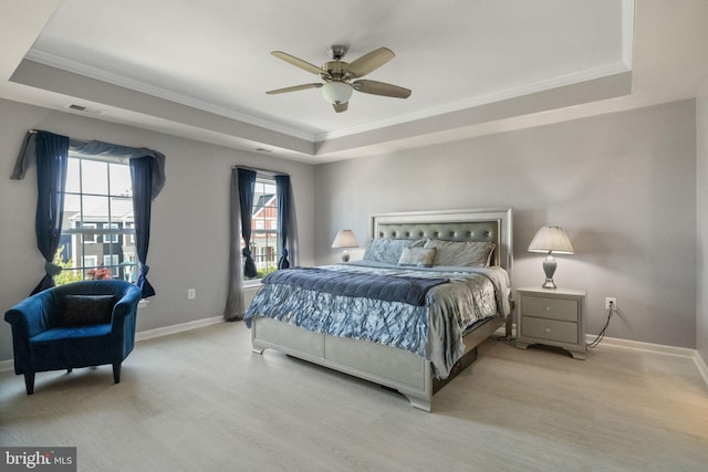 bedroom with a raised ceiling, ornamental molding, baseboards, and visible vents