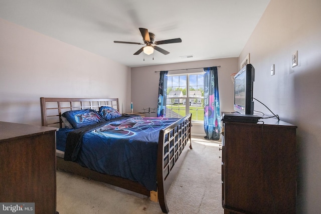 bedroom featuring ceiling fan, visible vents, and carpet