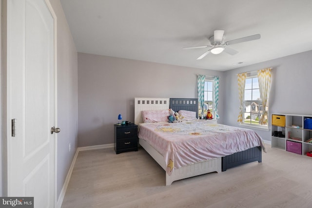 bedroom with baseboards, ceiling fan, and wood finished floors