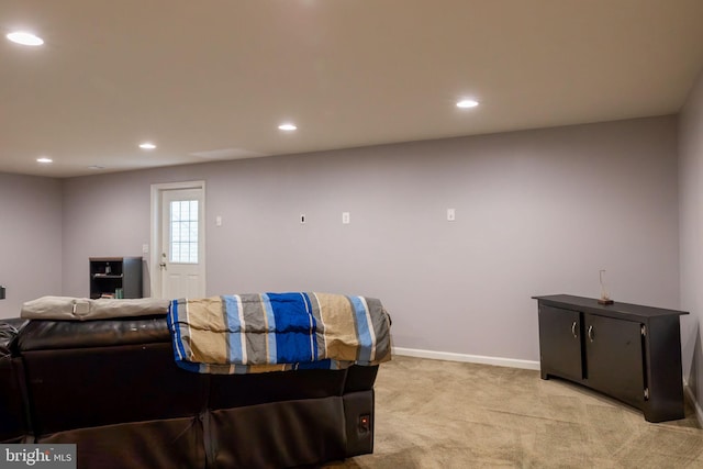 living room featuring recessed lighting, baseboards, and light colored carpet