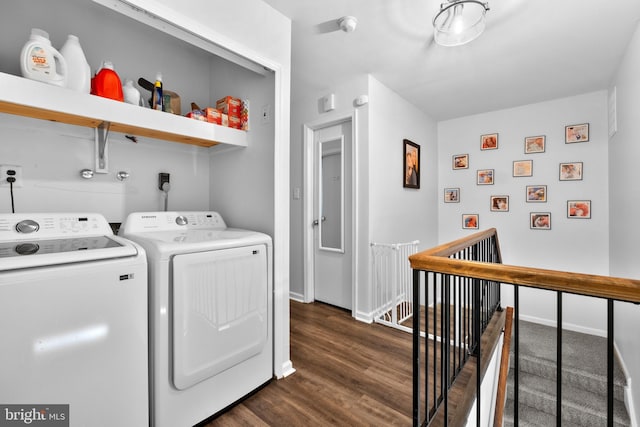 washroom with dark wood-type flooring and washer and clothes dryer