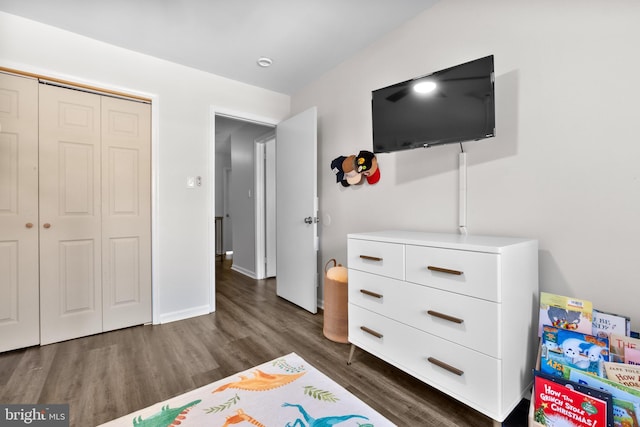 bedroom featuring dark hardwood / wood-style floors and a closet