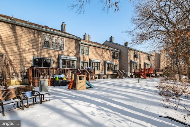 view of snow covered back of property