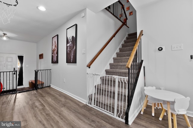 stairway with hardwood / wood-style floors