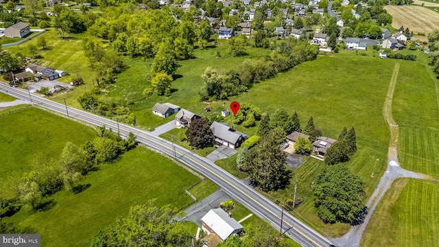 aerial view of property and surrounding area featuring nearby suburban area