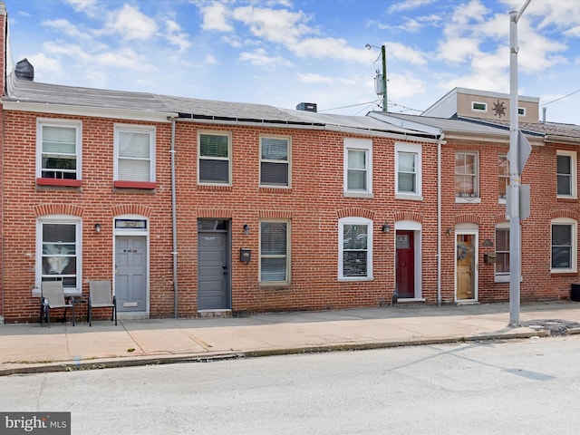 2437 Fleet St, Baltimore, MD 21224 - view of property featuring brick siding and roof with shingles