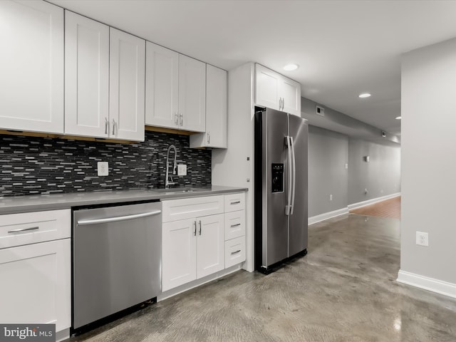 2437 Fleet St, Baltimore, MD 21224 - kitchen featuring stainless steel appliances, a sink, backsplash, baseboards, and white cabinetry
