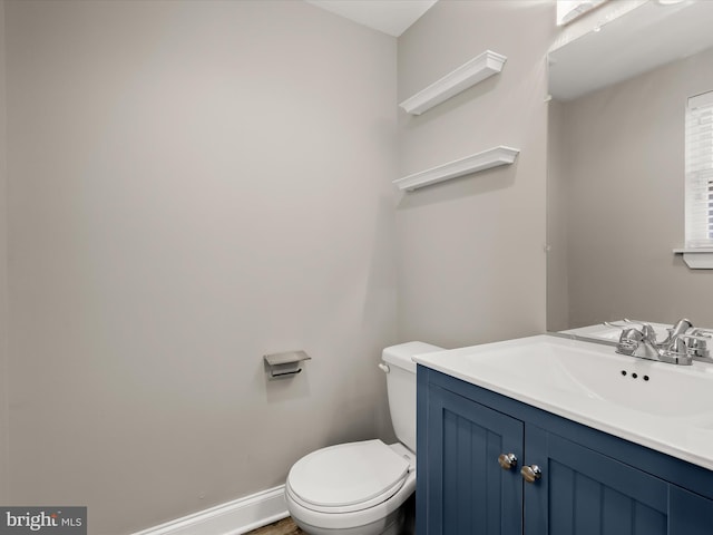 2437 Fleet St, Baltimore, MD 21224 - bathroom featuring toilet, vanity, and baseboards