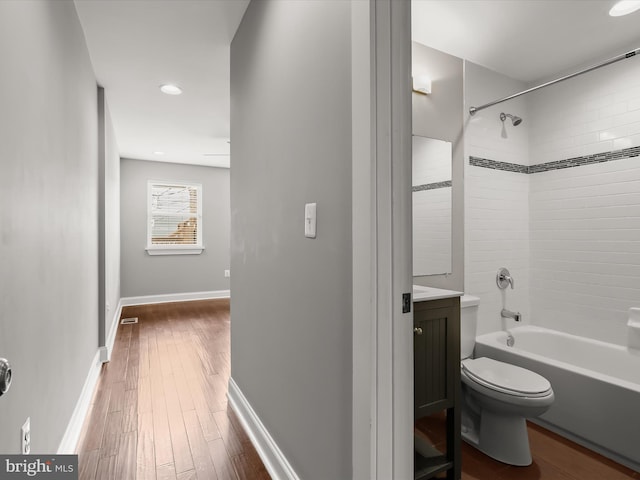 2437 Fleet St, Baltimore, MD 21224 - bathroom with bathing tub / shower combination, hardwood / wood-style flooring, toilet, and vanity