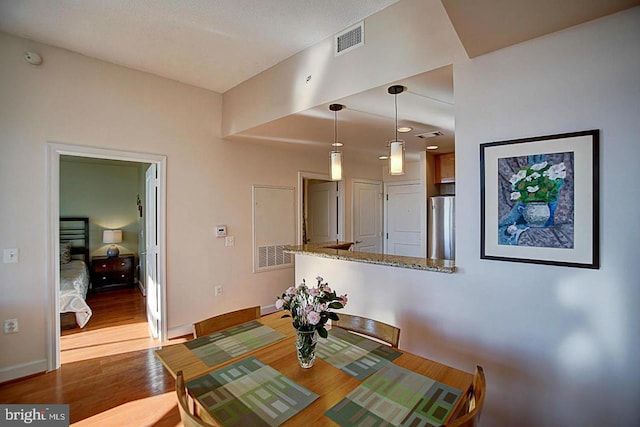 dining area with hardwood / wood-style flooring