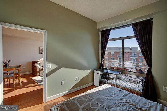 bedroom with hardwood / wood-style flooring and a textured ceiling