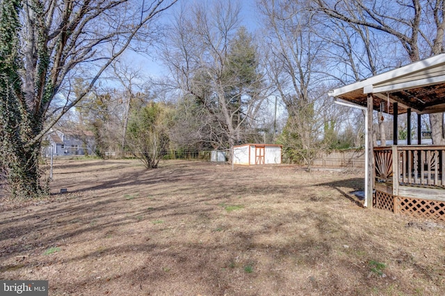 view of yard with a shed and a deck