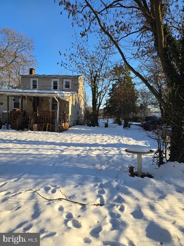 snow covered house with a porch