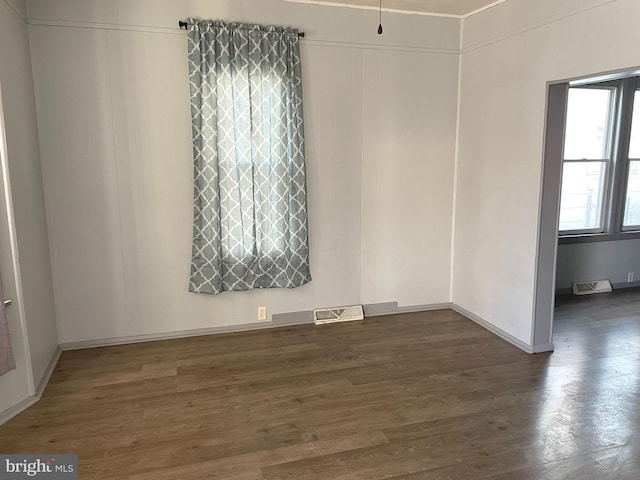 unfurnished room with dark hardwood / wood-style floors