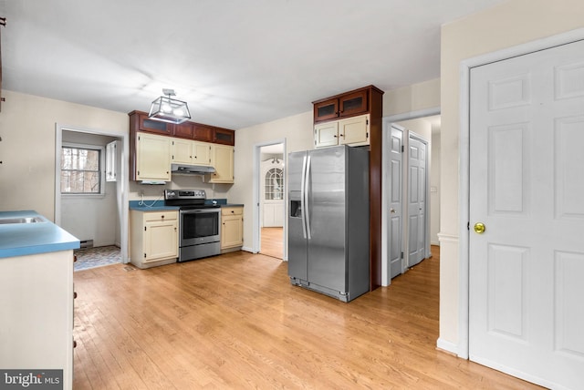 kitchen with baseboards, stainless steel appliances, light wood finished floors, and under cabinet range hood