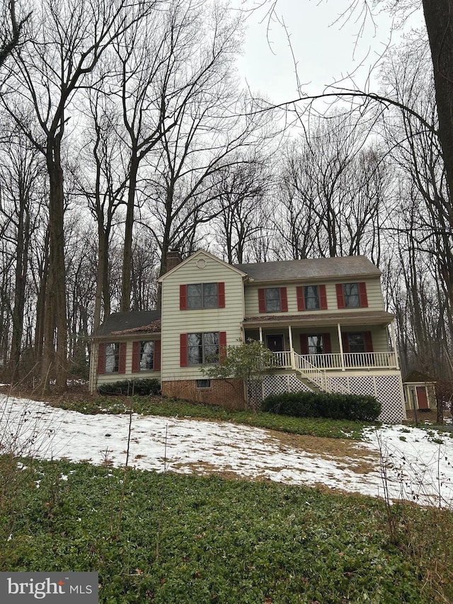 view of front of home with covered porch and a chimney