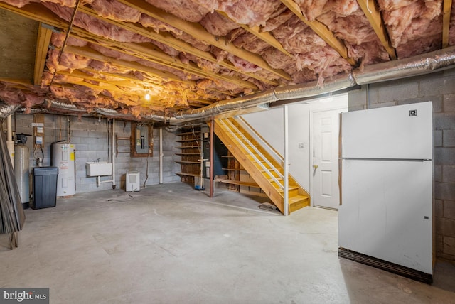 unfinished basement featuring water heater, stairway, freestanding refrigerator, a sink, and electric panel