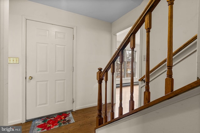 entrance foyer with stairway, baseboards, and wood finished floors