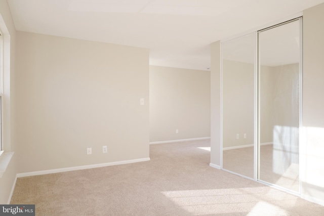 interior space with light colored carpet and a closet