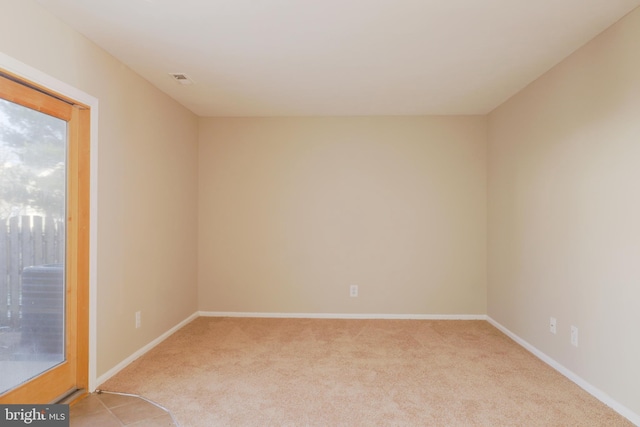 unfurnished room featuring light colored carpet