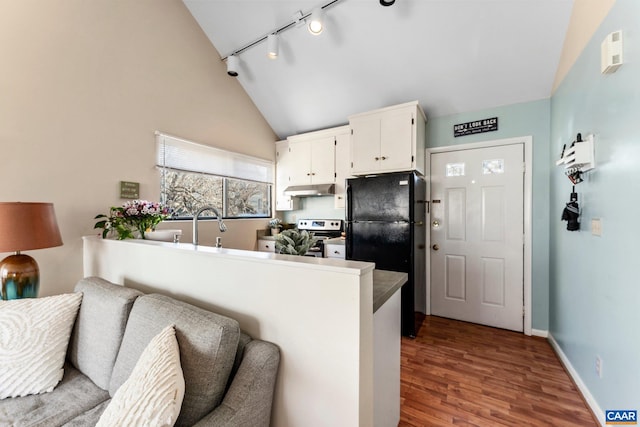 kitchen featuring vaulted ceiling, black refrigerator, white cabinetry, kitchen peninsula, and electric stove