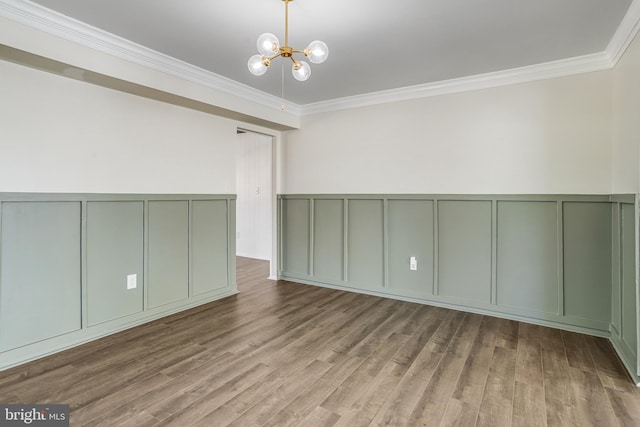 unfurnished room with crown molding, wood-type flooring, and a chandelier