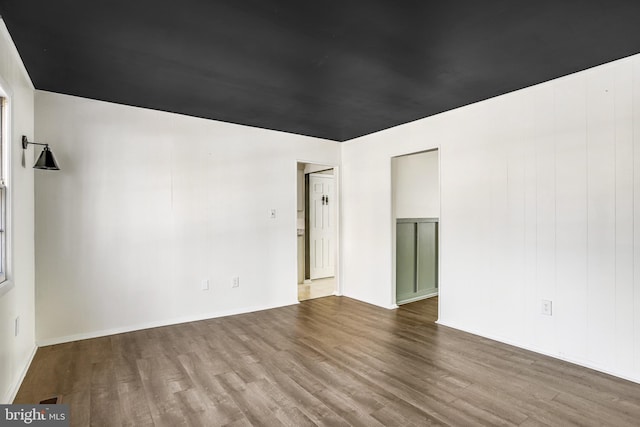 unfurnished room with wood-type flooring