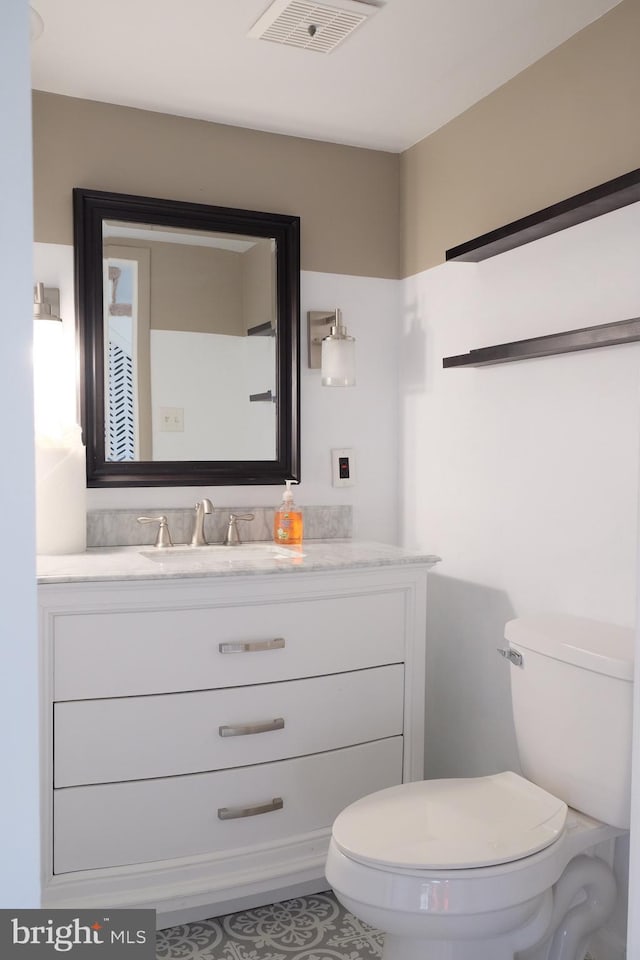 bathroom featuring vanity and toilet