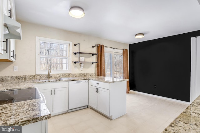 kitchen featuring white cabinetry, sink, white dishwasher, and kitchen peninsula