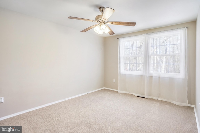 spare room with carpet floors and ceiling fan