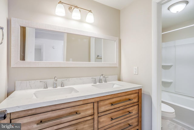 full bathroom featuring vanity, bathtub / shower combination, and toilet