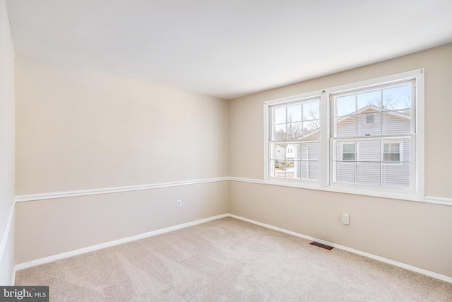 spare room with light colored carpet