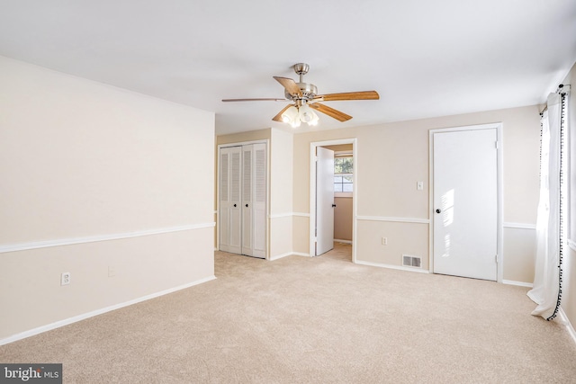 unfurnished room with ceiling fan and light carpet