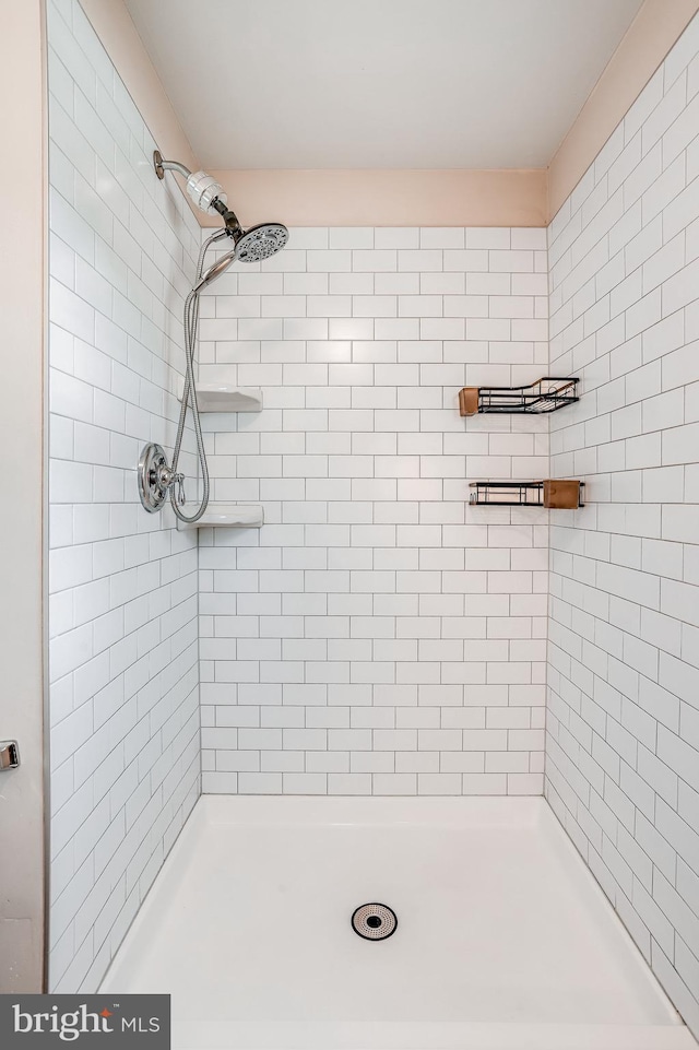 bathroom with tiled shower