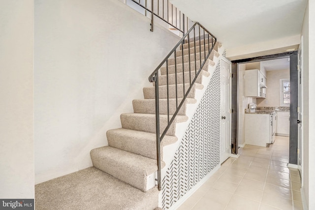 stairway with tile patterned floors