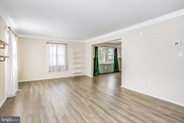 unfurnished room with crown molding and light wood-type flooring