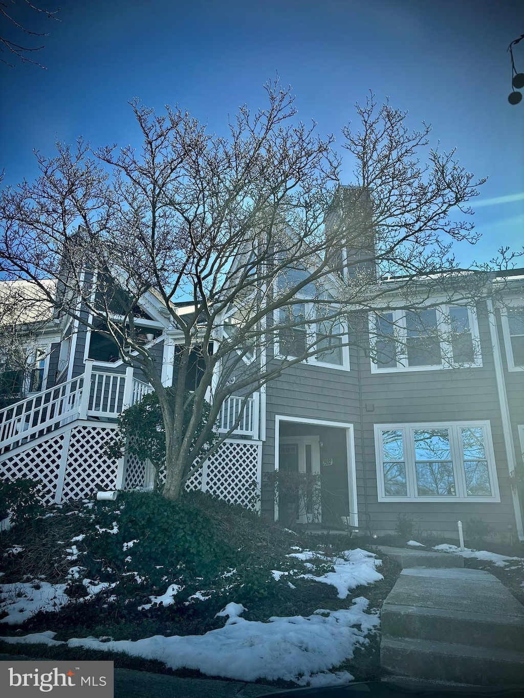 view of snow covered rear of property