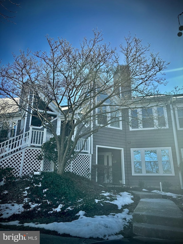 view of snow covered rear of property