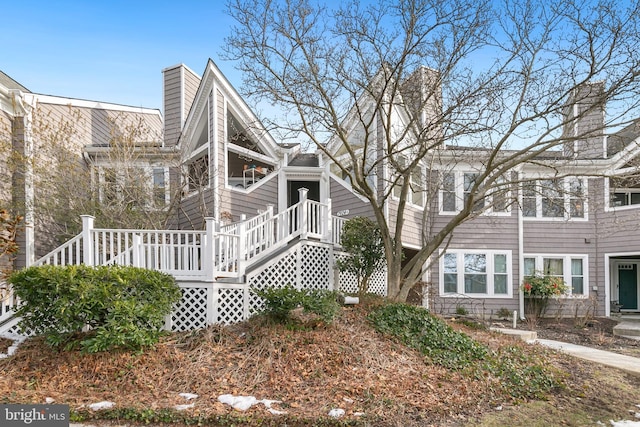 view of property exterior with a wooden deck