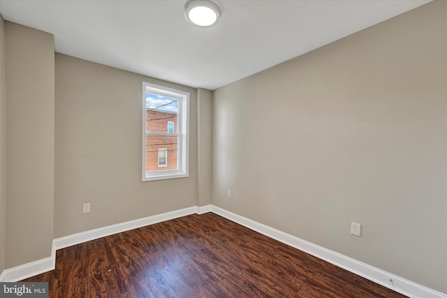 empty room featuring dark hardwood / wood-style flooring