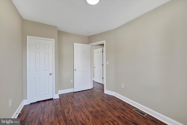 unfurnished bedroom featuring dark wood-type flooring