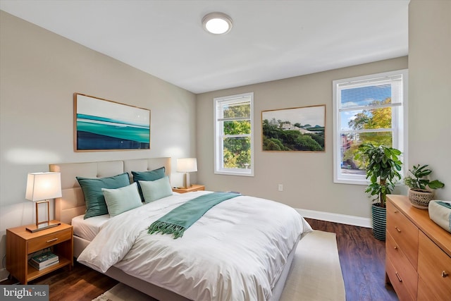 bedroom with dark hardwood / wood-style flooring