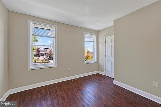 unfurnished room with dark hardwood / wood-style floors