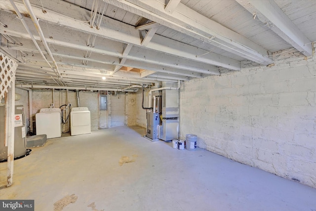 basement with separate washer and dryer, heating unit, and electric panel