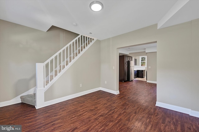 unfurnished living room with dark hardwood / wood-style floors